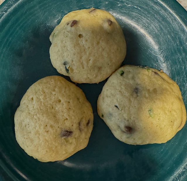 Three zucchini cake cookies on a green plate