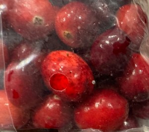 Fresh cranberries in clear plastic packaging.