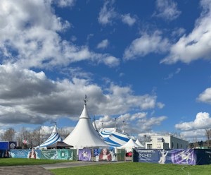 This is a photo of the Big Top and other buildings/trailers for Cirque du Soleil: Echo. It's a bright sunny day, and it's a view from afar in Marymoor Park in Redmond, Washington.